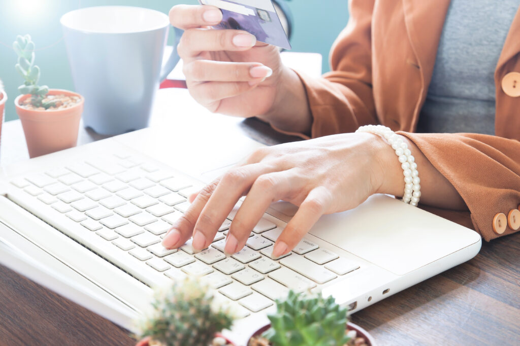 working woman using laptop computer and holding credit card, onl